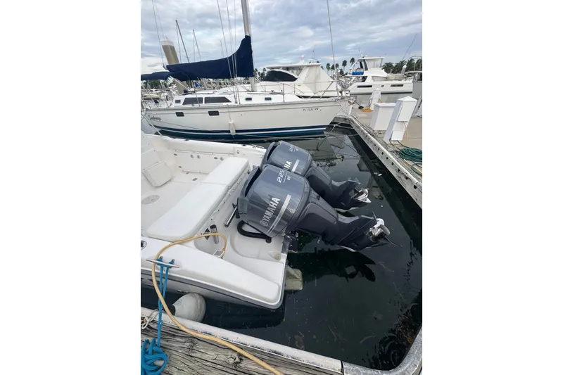 Slide: The Image of 2004 Century 2600 Walk-Around boat with twin Yamaha outboard motors docked at marina. - 2