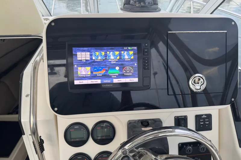 Slide: The Image of Century 2600 Walk-Around 2004 boat dashboard with Garmin navigation system and controls. - 26