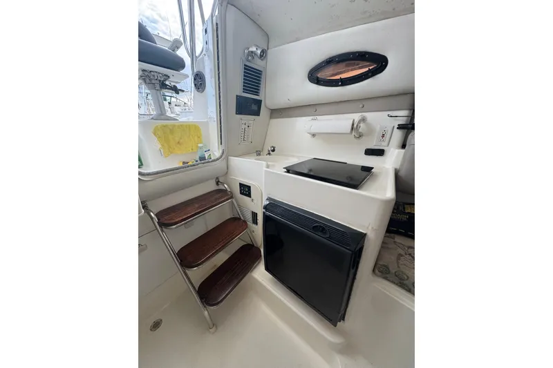 Slide: The Image of 2004 Century 2600 Walk-Around cabin interior with kitchenette and wooden steps. - 7
