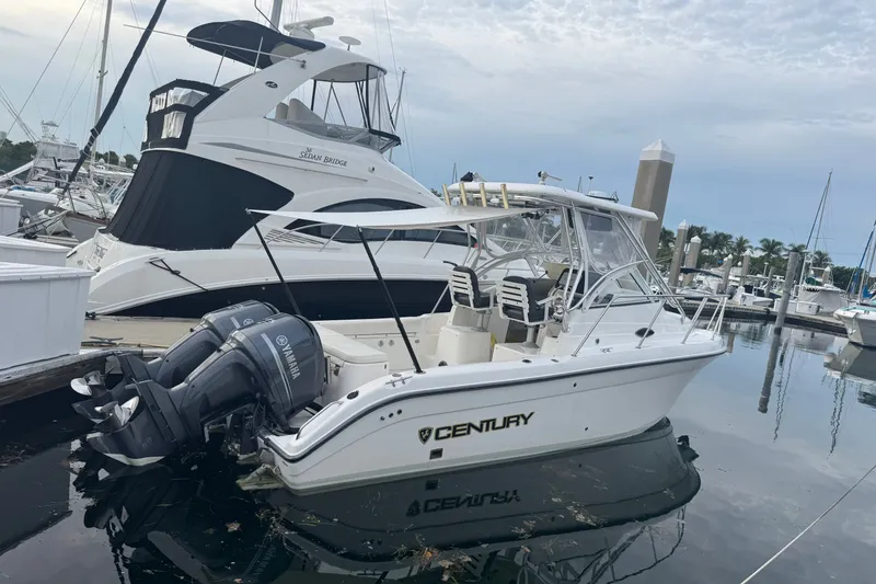 The Image of 2004 Century 2600 Walk-Around boat docked with Yamaha engines in marina. - 0