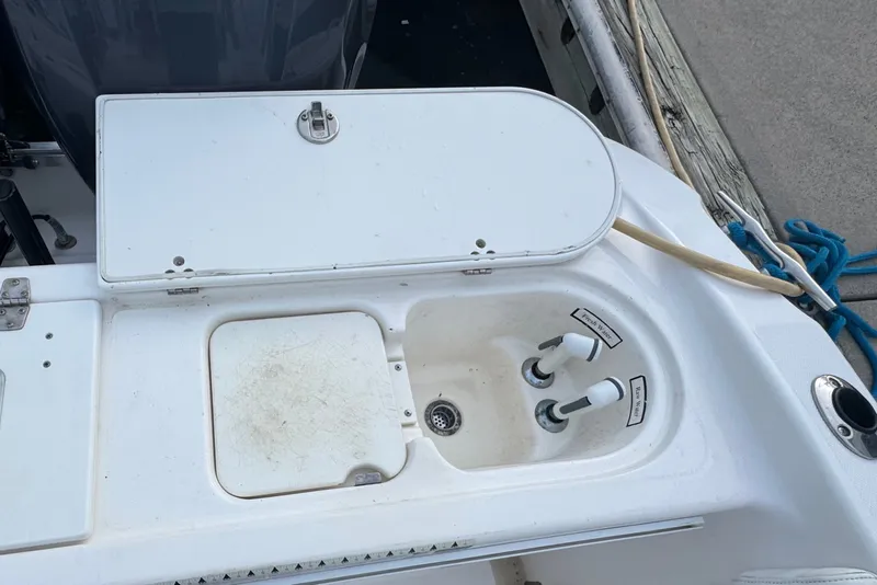 Slide: The Image of 2004 Century 2600 Walk-Around boat sink and storage compartment detail. - 21