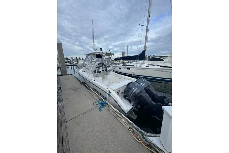 Slide: The Image of 2004 Century 2600 Walk-Around boat docked with twin Yamaha engines. - 1