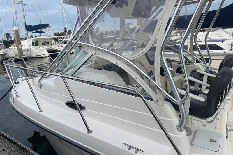 Slide: The Image of 2004 Century 2600 Walk-Around boat docked at marina, featuring sleek design and comfortable seating. - 22