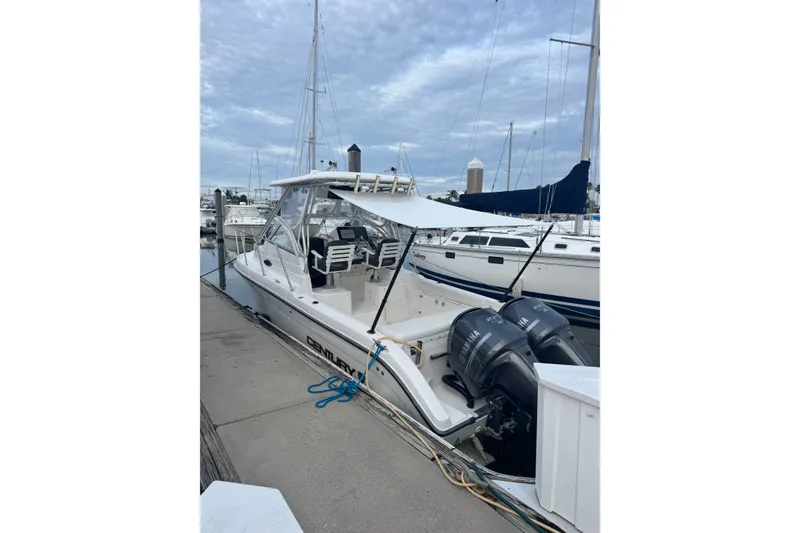 Slide: The Image of 2004 Century 2600 Walk-Around boat docked with twin Yamaha engines. - 12