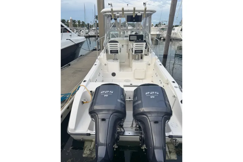 Slide: The Image of 2004 Century 2600 Walk-Around boat with twin Yamaha 225 engines docked at marina. - 28