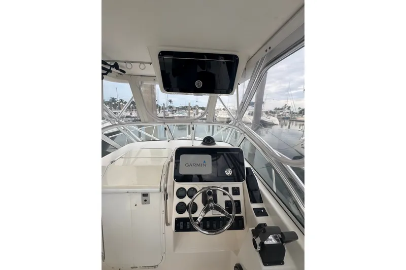 Slide: The Image of 2004 Century 2600 Walk-Around boat helm with Garmin navigation system, docked at marina. - 6