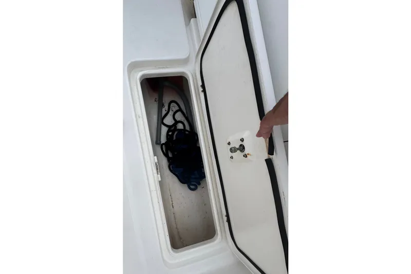 Slide: The Image of Storage compartment on a 2004 Century 2600 Walk-Around boat, containing ropes. - 15