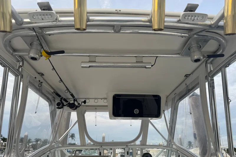 Slide: The Image of 2004 Century 2600 Walk-Around boat interior with fishing rod holders and equipment. - 23
