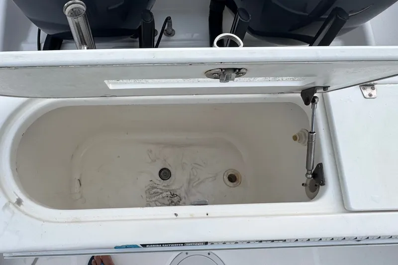 Slide: The Image of Open storage compartment on 2004 Century 2600 Walk-Around boat, showing interior details. - 20