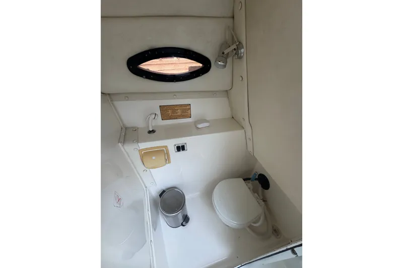 Slide: The Image of Interior of 2004 Century 2600 Walk-Around boat, featuring compact bathroom amenities. - 11