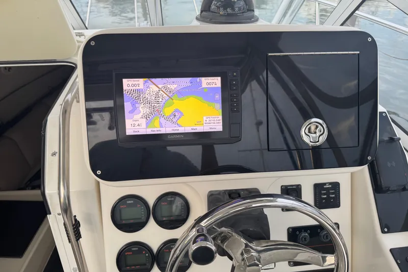 Slide: The Image of Century 2600 Walk-Around 2004 boat dashboard with Garmin GPS and navigation instruments. - 25