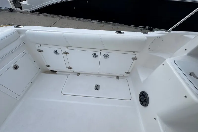 Slide: The Image of 2004 Century 2600 Walk-Around boat interior with storage compartments and seating. - 17