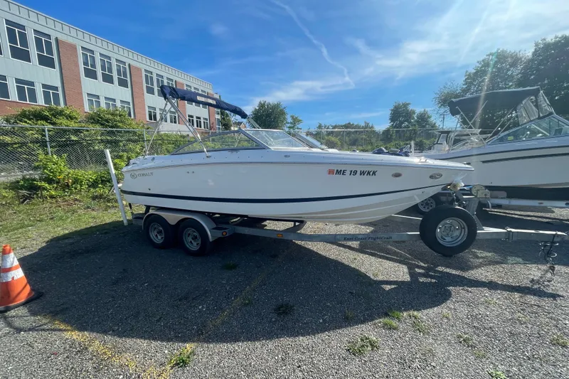 Slide: The Image of 2008 Cobalt 202 boat on trailer, parked outdoors near a building. - 18