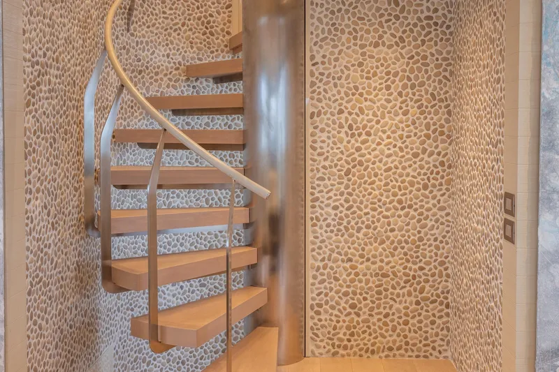 Slide: The Image of Spiral staircase with pebble-patterned walls on 2019 Sanlorenzo SD112 yacht. - 28