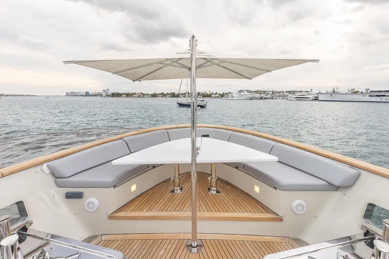 Slide: The Image of Luxurious 2019 Sanlorenzo SD112 yacht deck with seating, table, and umbrella on calm waters. - 41
