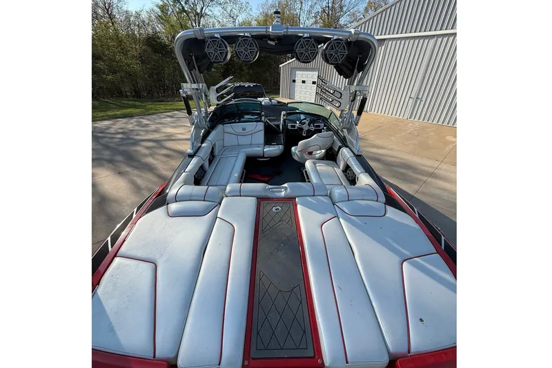 Slide: The Image of The image shows the interior of a 2013 MasterCraft XStar boat with gray and red seating. - 1