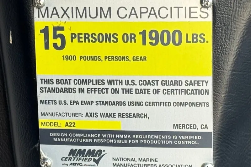 Slide: The Image of Axis A22 2011 boat capacity label: 15 persons or 1900 lbs, USCG compliant. - 34