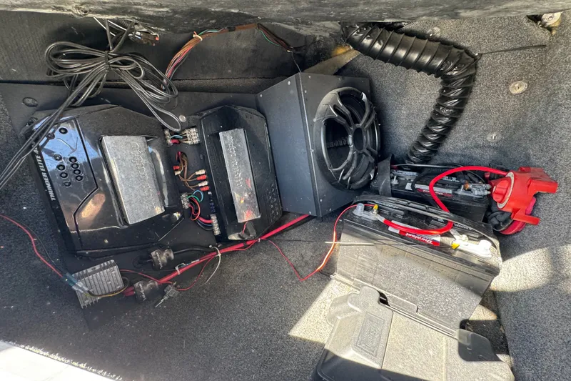 Slide: The Image of 2011 Axis A22 boat interior showing audio system and wiring components. - 26