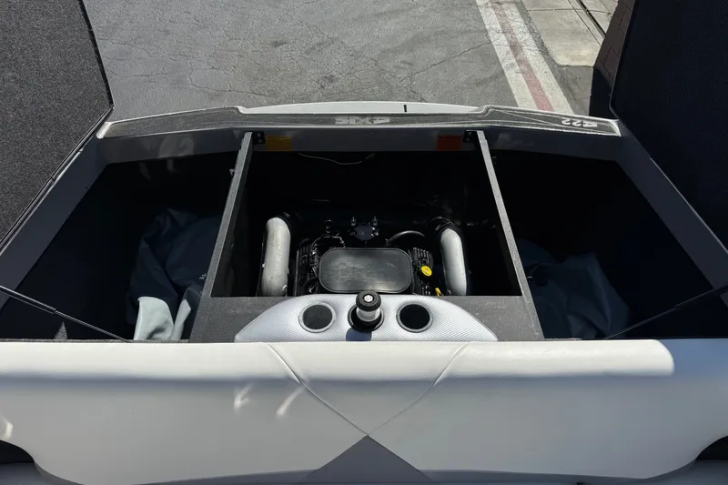 Slide: The Image of Open engine compartment of 2011 Axis A22 boat, showing engine details. - 22