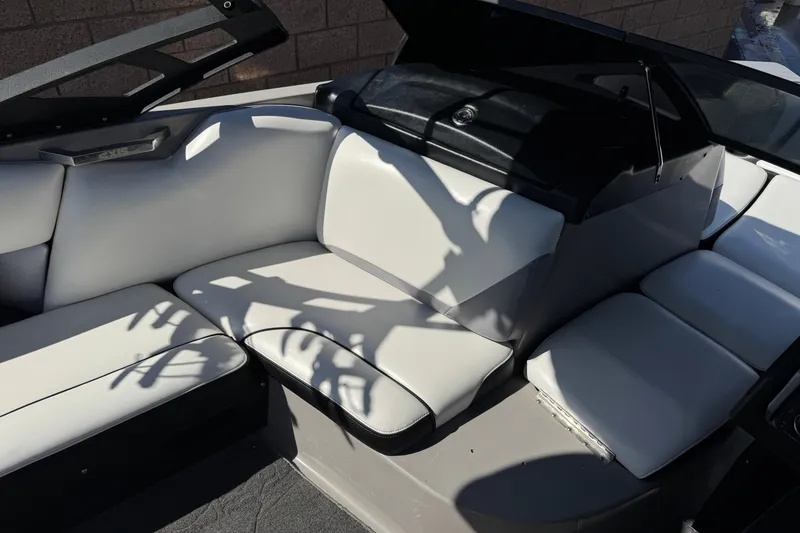 Slide: The Image of Interior of a 2011 Axis A22 boat with white seating and black accents. - 24