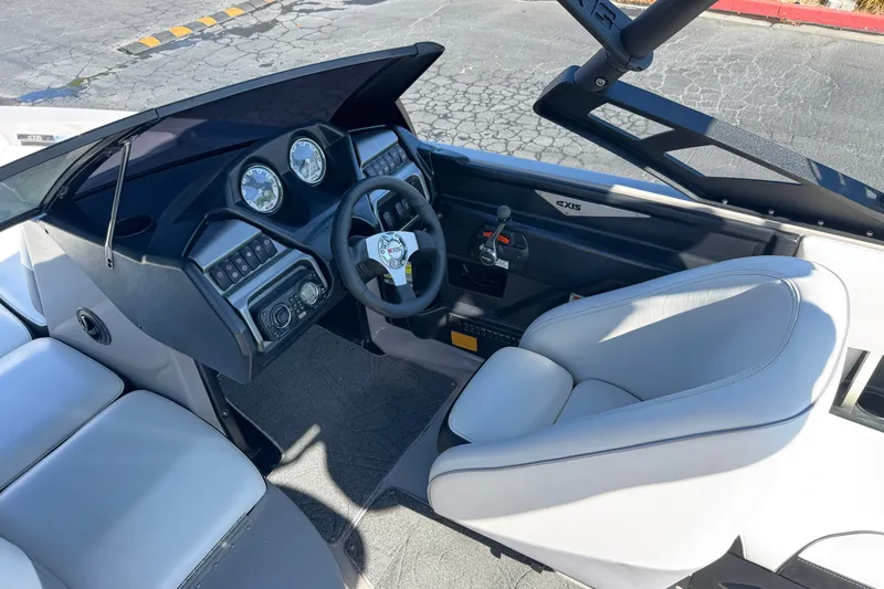 Slide: The Image of Interior of a 2011 Axis A22 boat featuring steering wheel and dashboard controls. - 27