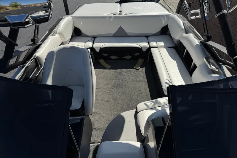 Slide: The Image of Interior of a 2011 Axis A22 boat with white seating and spacious layout. - 14