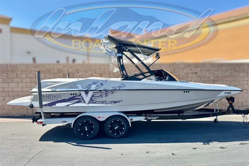 The Image of 2011 Axis A22 boat on trailer, Vandal Edition, displayed outdoors. - 0