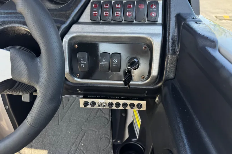 Slide: The Image of Dashboard controls of a 2011 Axis A22 boat with steering wheel and ignition key. - 30