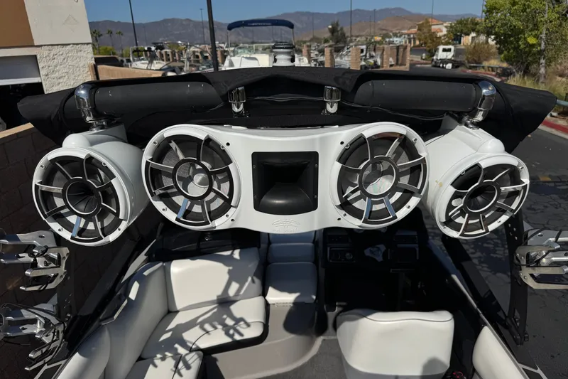Slide: The Image of 2011 Axis A22 boat with mounted speakers and cushioned seating. - 16