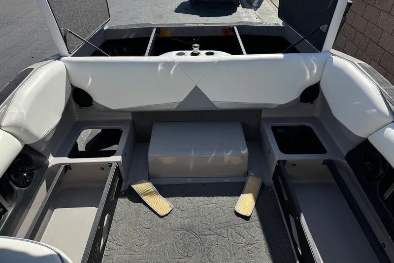Slide: The Image of 2011 Axis A22 boat interior with open storage compartments and seating. - 21