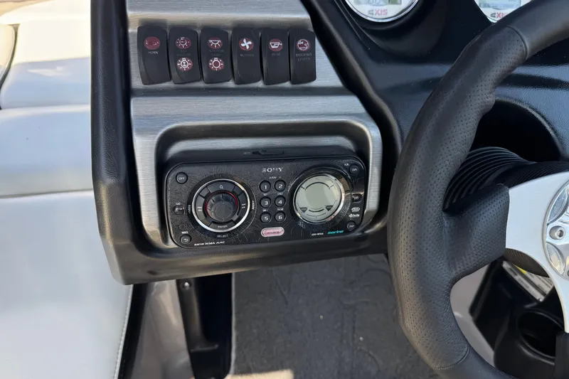 Slide: The Image of Dashboard of a 2011 Axis A22 boat with control panel and steering wheel. - 29