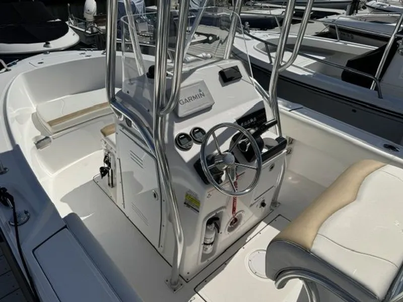 Slide: The Image of The image shows the cockpit of a 2023 Edgewater 188CC boat with a helm console and seating. - 3