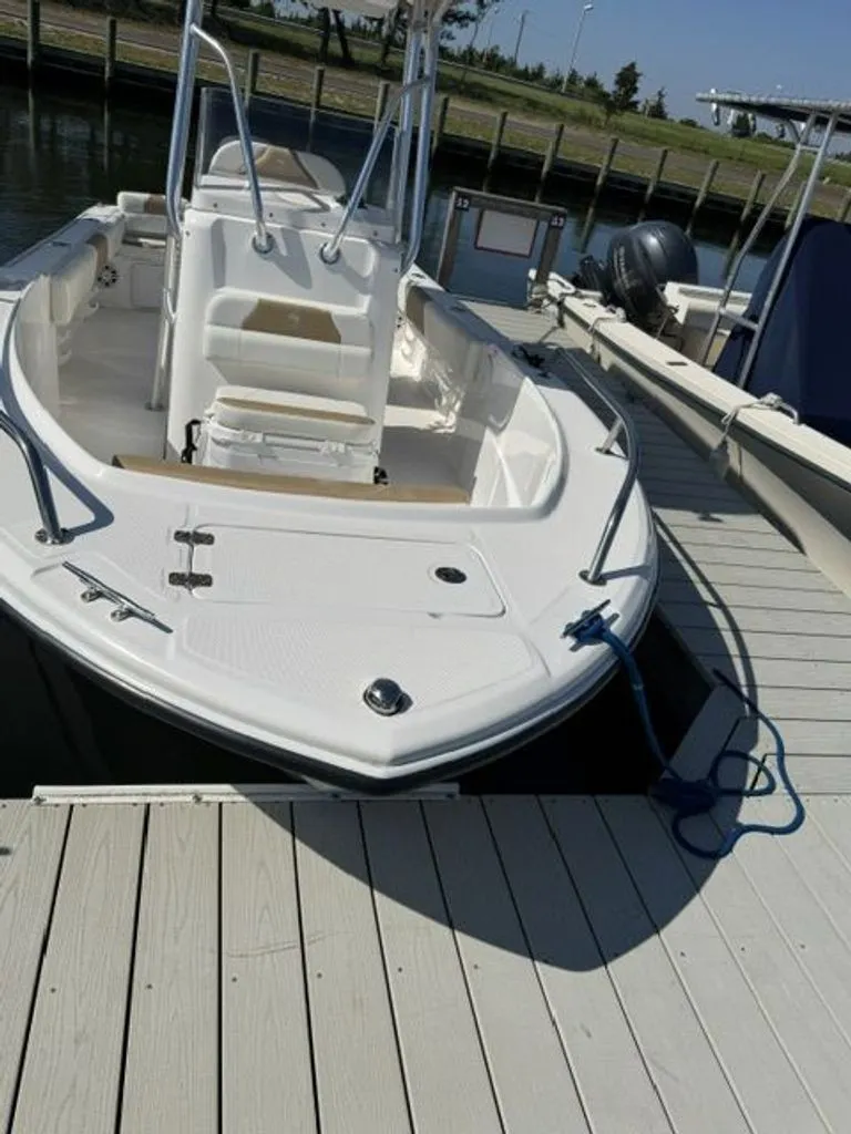 Slide: The Image of An Edgewater 188CC boat from 2023 docked at a pier. - 2