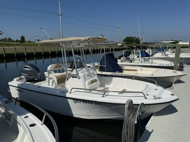 The Image of A 2023 Edgewater 188CC boat docked in a sunny marina. - 0