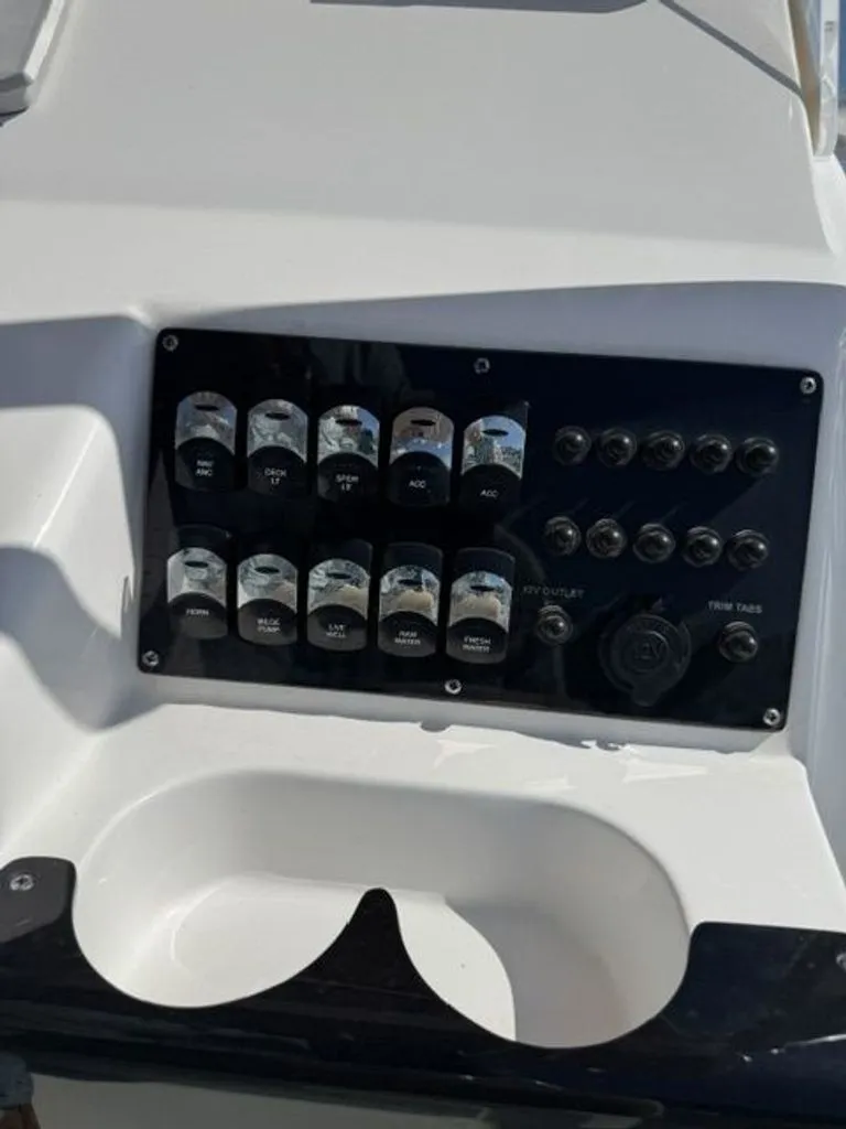 Slide: The Image of The image shows the dashboard of an Edgewater 188CC boat with various switches and buttons. - 4