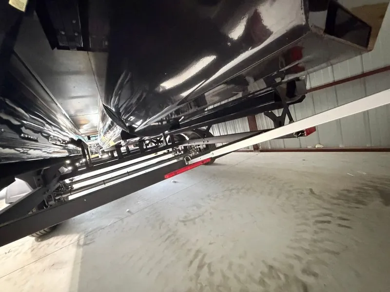 Slide: The Image of Underside view of a Regency 230 LE3 boat in a storage facility. - 29