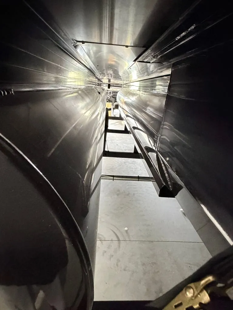 Slide: The Image of Close-up of the hull of a 2025 Regency 230 LE3, showing the sleek black surface. - 28