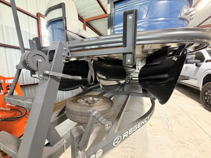 Slide: The Image of A 2025 Regency 230 LE3 on a trailer in a storage facility. - 19