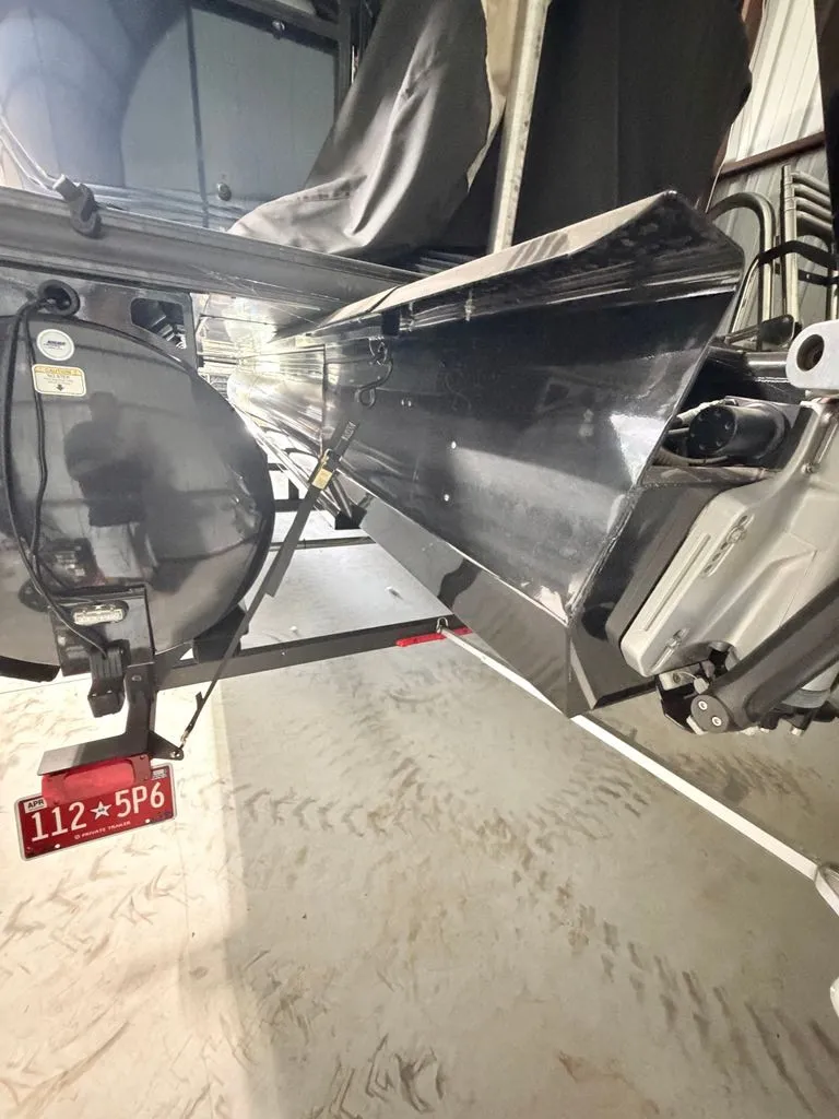 Slide: The Image of Regency 230 LE3 2025: Close-up of the hull and engine in a storage facility. - 26