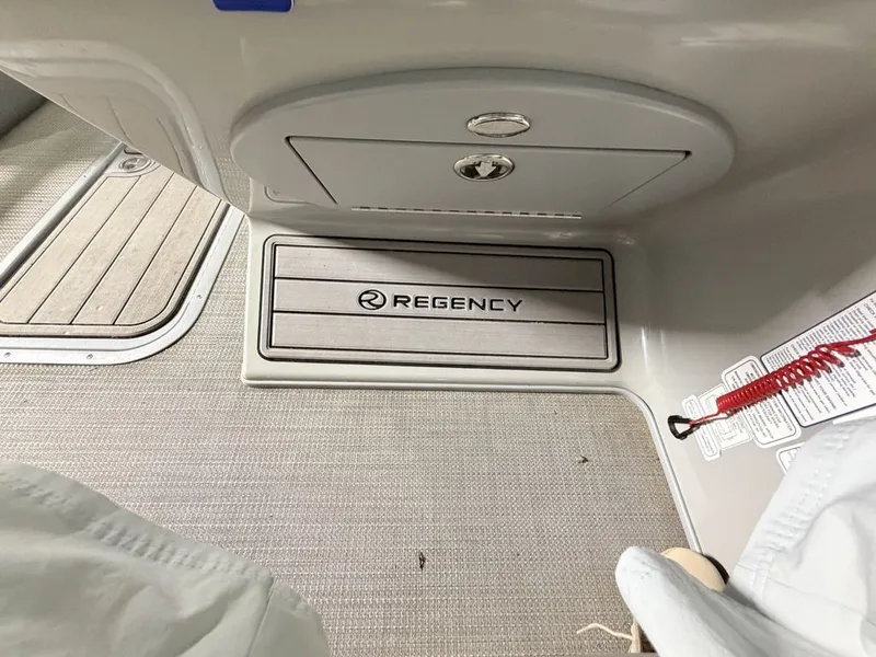 Slide: The Image of Interior of a Regency 230 LE3 with carpeted floor and storage hatch. - 16