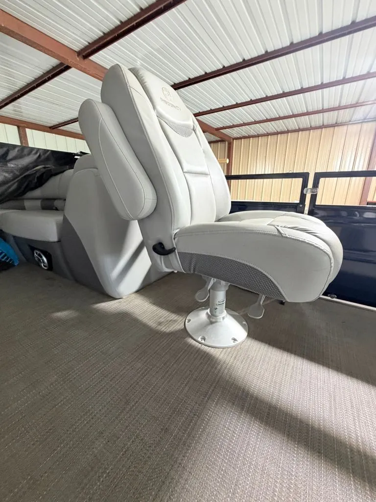 Slide: The Image of A luxurious, padded captain's chair in a modern boat, surrounded by a covered area. - 14