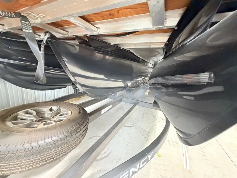 Slide: The Image of Underside view of a Regency 230 LE3 pontoon boat on a trailer. - 33