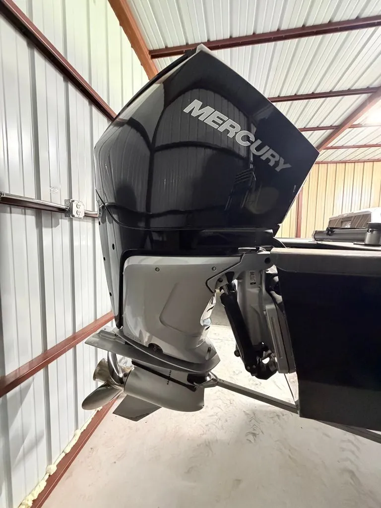 Slide: The Image of A Mercury outboard motor is attached to a boat stored in a metal building. - 22