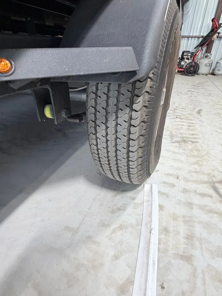 Slide: The Image of Close-up of a boat trailer wheel in a garage. - 32