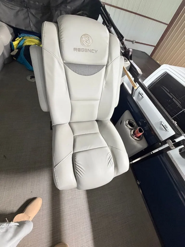 Slide: The Image of A luxurious, padded seat with the Regency logo on a boat. - 15