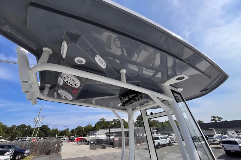 Slide: The Image of 2027 Tidewater 210 LXF boat with modern T-top and speakers, outdoor setting. - 15