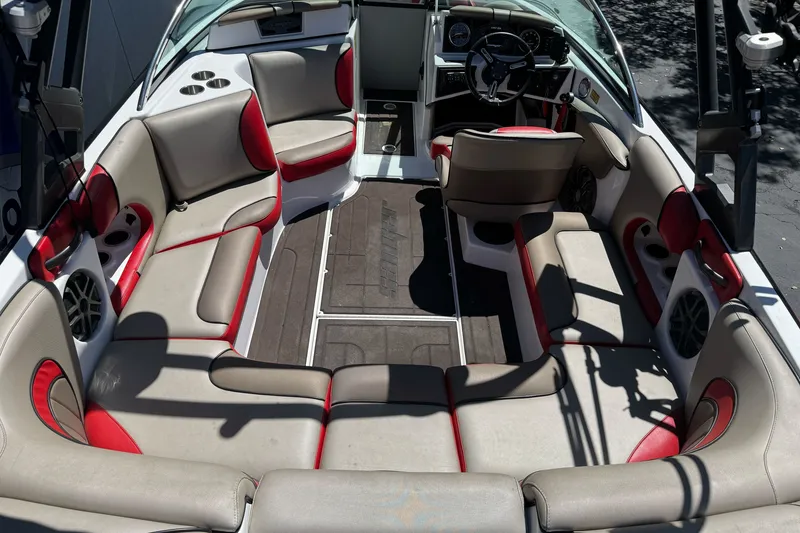 Slide: The Image of Interior of a 2019 Sanger 212 SL boat with red and gray seating. - 11