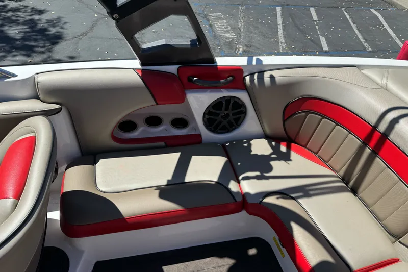 Slide: The Image of Interior of a 2019 Sanger 212 SL boat with red and beige seating. - 15