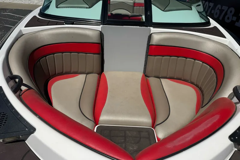 Slide: The Image of Interior of a 2019 Sanger 212 SL boat with red and beige seating. - 7