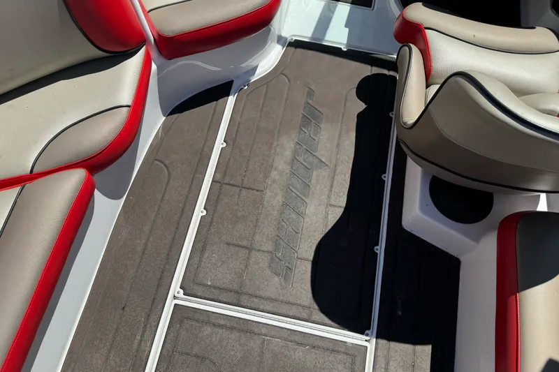 Slide: The Image of Interior of a 2019 Sanger 212 SL boat with red and beige seating. - 17